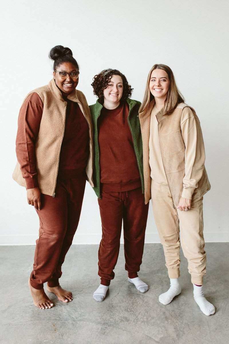 ADULT SHERPA/CORDUROY REVERSIBLE VEST in tan and beige, worn open to show its soft sherpa texture and contrasting sides