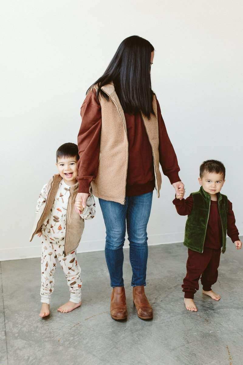ADULT SHERPA/CORDUROY REVERSIBLE VEST in tan sherpa with a brown corduroy reverse, shown worn open
