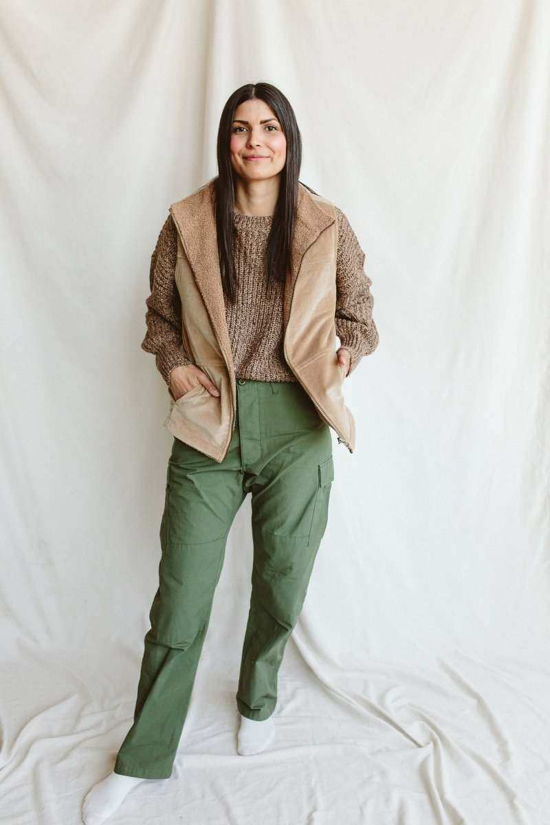 ADULT SHERPA/CORDUROY REVERSIBLE VEST in tan with a soft sherpa lining, worn open with a wide collar and pockets