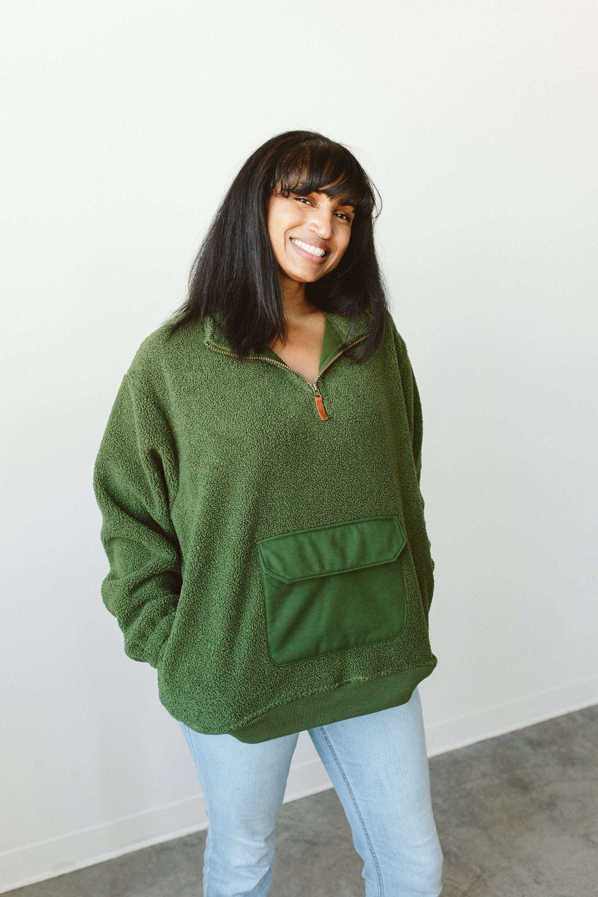 Adult Sherpa Zip Pullover in spruce green plush fleece, featuring a quarter-zip neckline and large front pocket