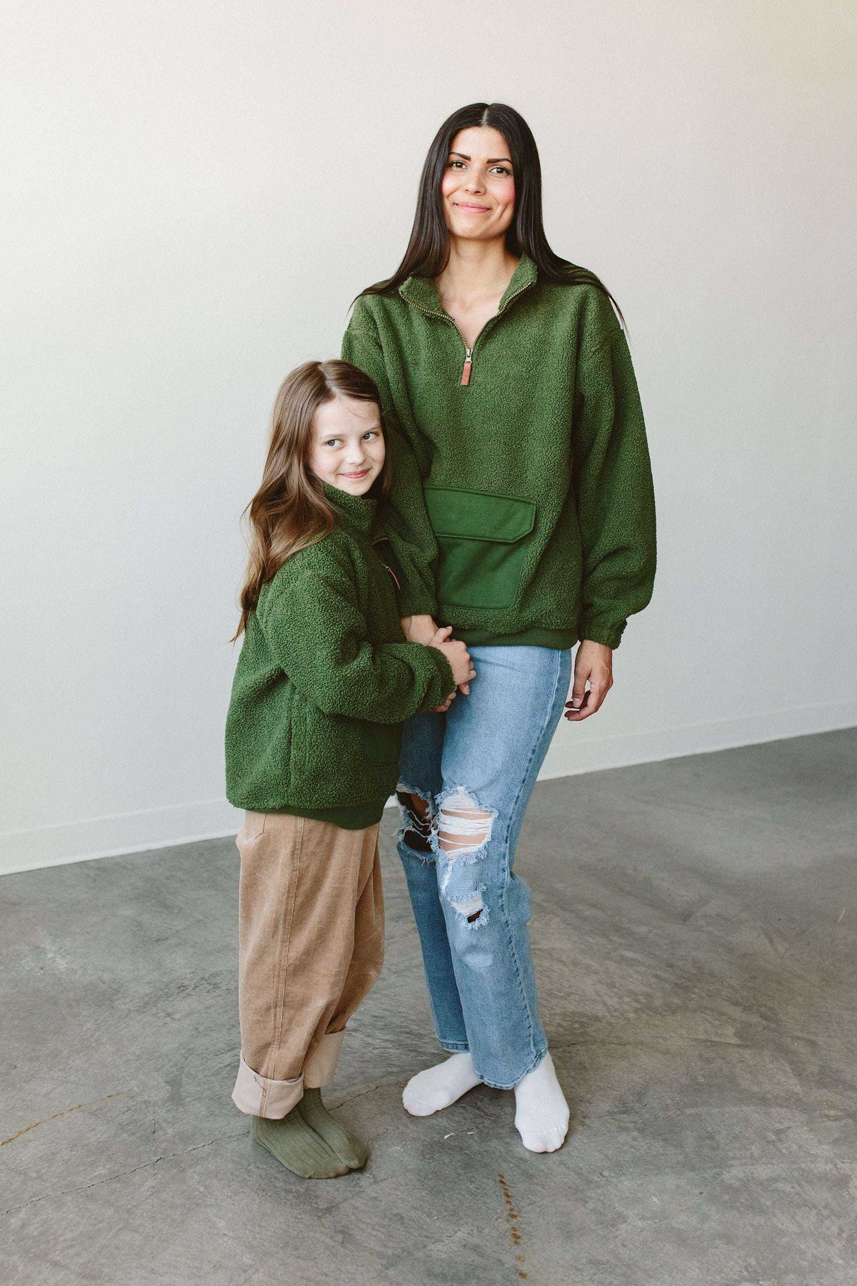 Adult Sherpa Zip Pullover in forest green plush fleece, with a half-zip neckline and front kangaroo pocket, worn by two people