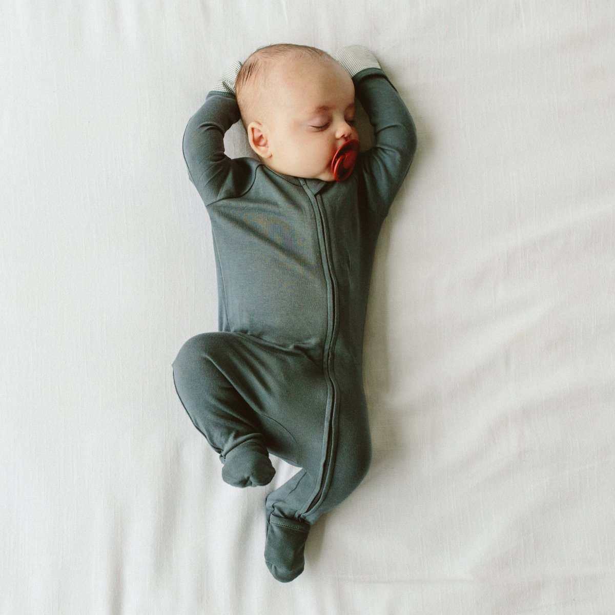 GROW WITH YOU FOOTIE in dark charcoal gray, with a smooth fabric finish, full-length zipper and convertible feet