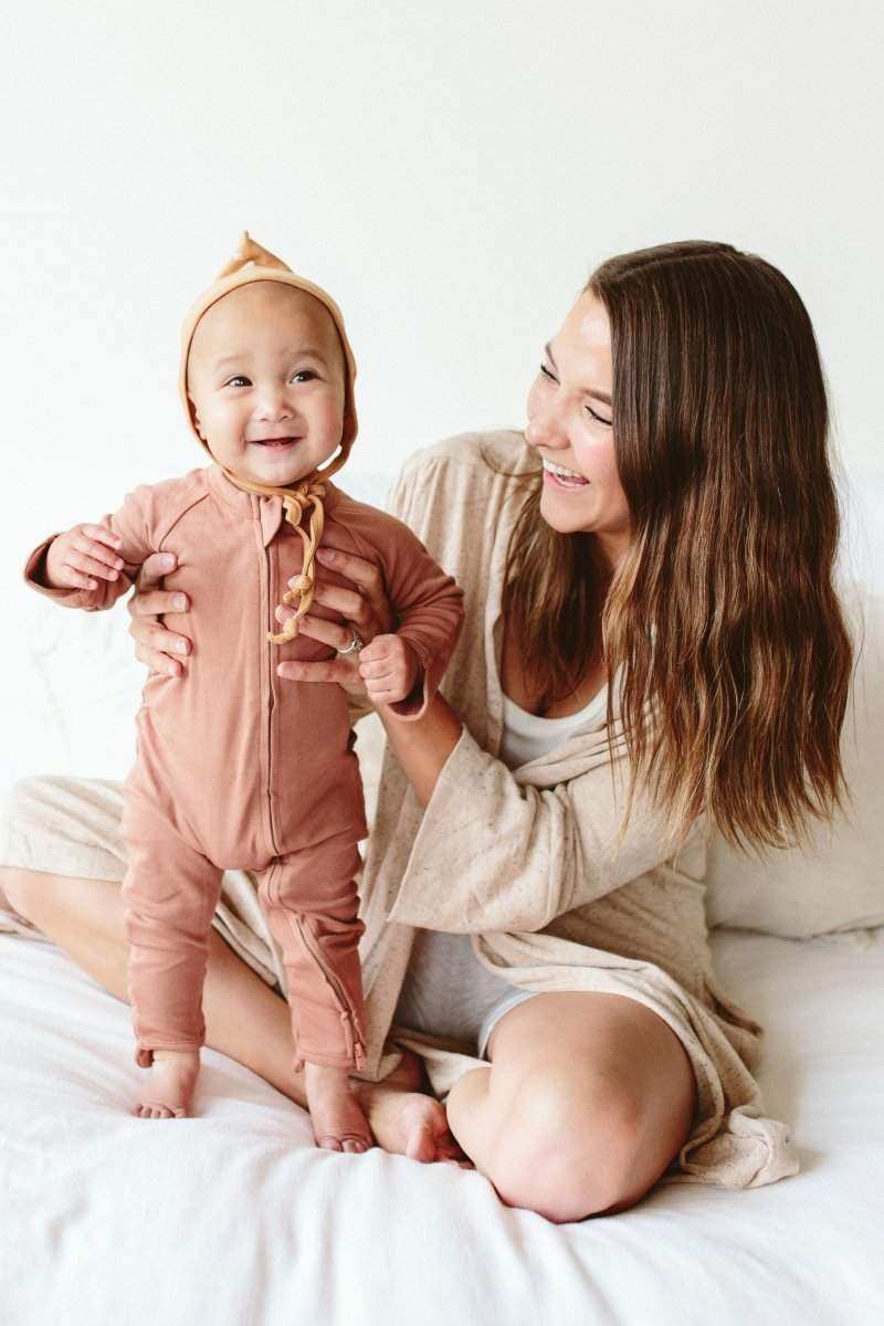 GROW WITH YOU FOOTIE in dusty rose bamboo cotton, with a front zip, matching pointed bonnet and covered feet