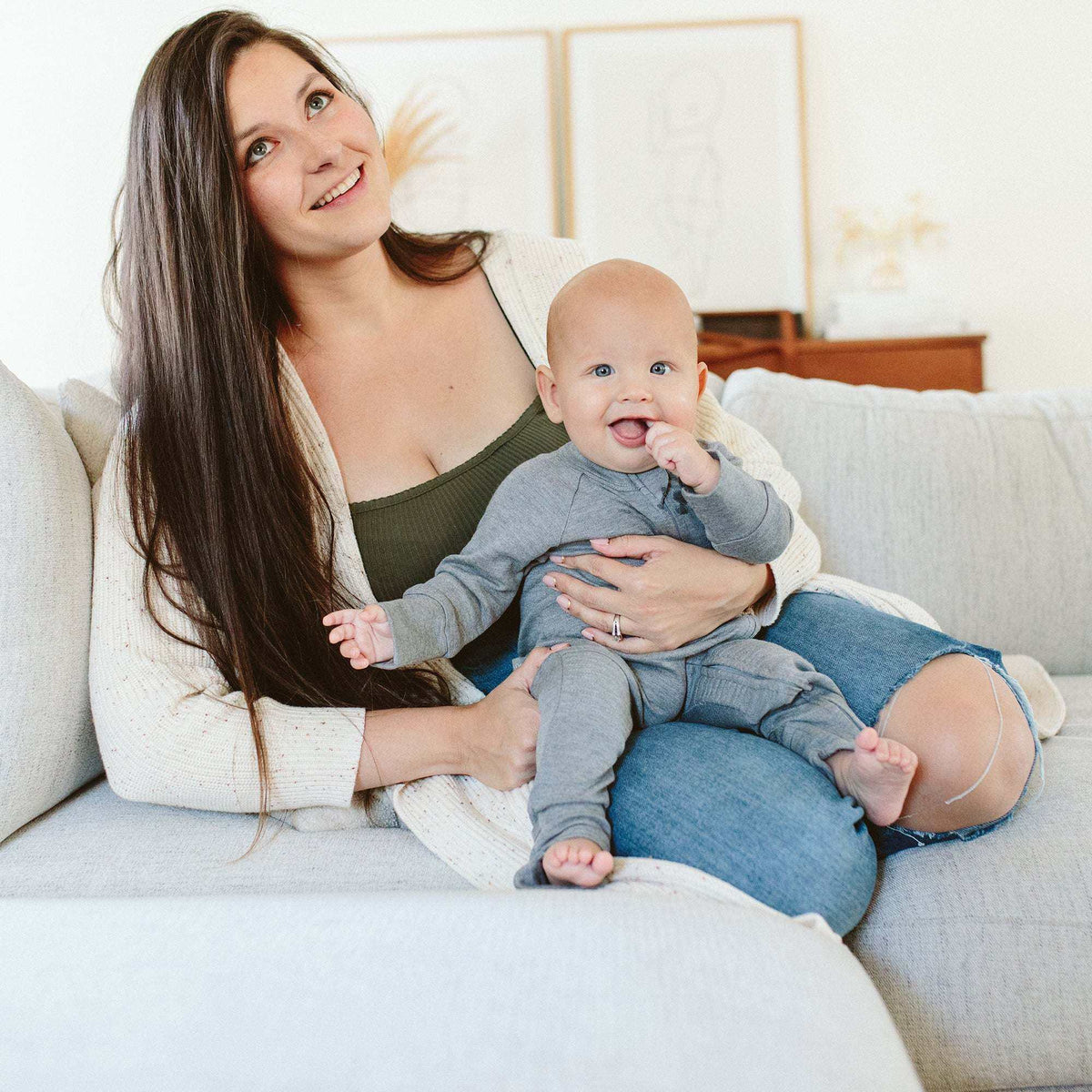 GROW WITH YOU FOOTIE in soft gray, worn by a baby, with long sleeves, covered legs, and foot openings