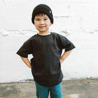 OVERSIZED TEE in black cotton with a plain design and boxy short sleeves, worn with teal trousers
