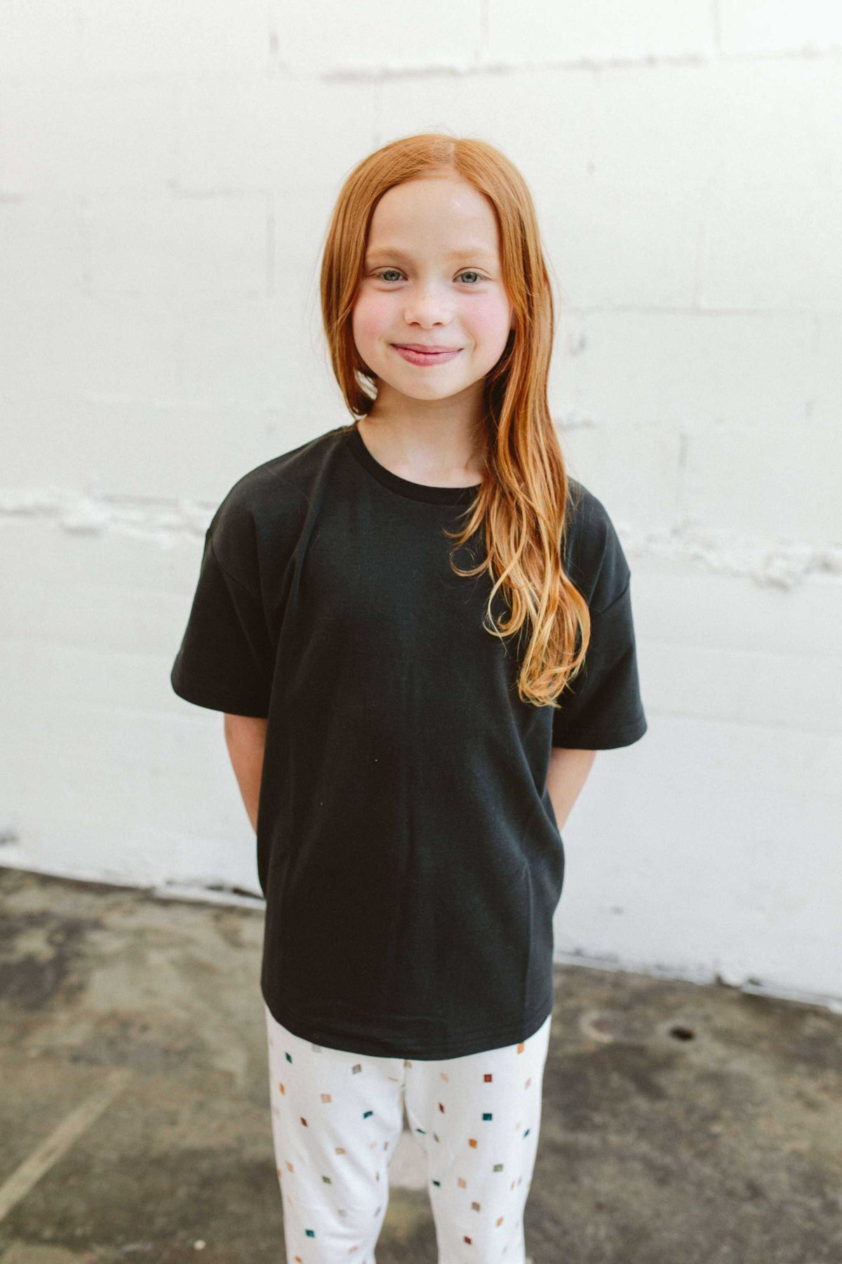 OVERSIZED TEE in charcoal black cotton with a soft, solid finish and relaxed boxy silhouette with short sleeves