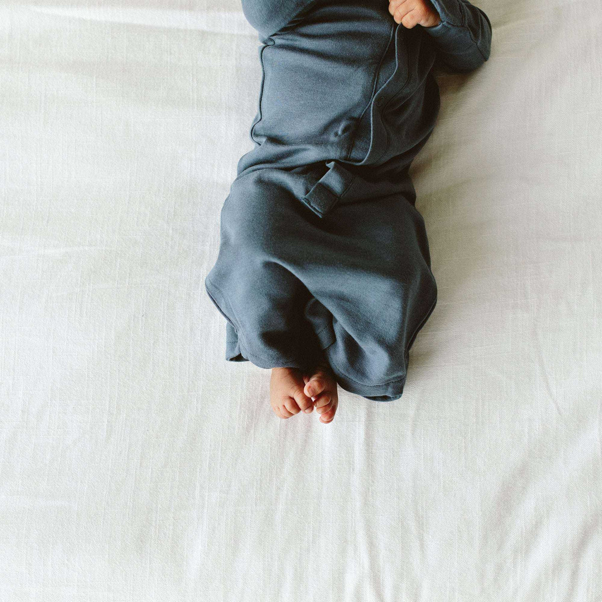 PREEMIE 24 HOUR CONVERTIBLE GOWN in solid midnight blue, with soft fabric, long sleeves and a gathered convertible hem