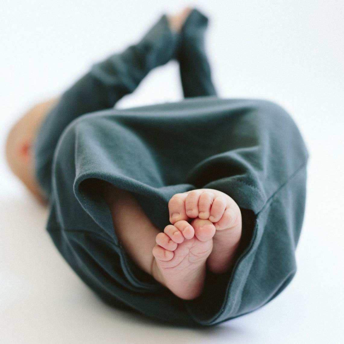 PREEMIE 24 HOUR CONVERTIBLE GOWN in deep midnight blue, soft fabric with a gathered opening and enclosed baby feet
