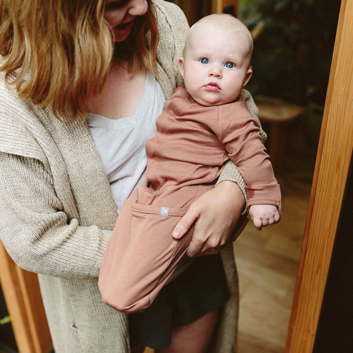 Quiet Night Starter Set with a baby wearing a dusty rose long-sleeve convertible gown with fold-over feet