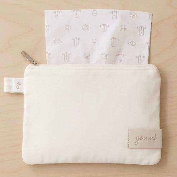 Quiet Night Starter Set featuring an ivory fabric pouch with a Goumi label and a subtle baby clothing print