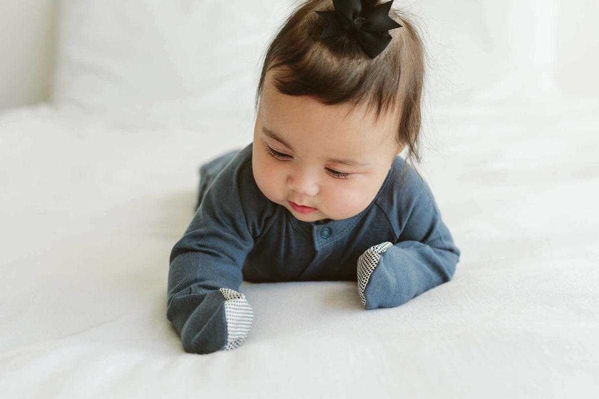Quiet Night Starter Set featuring a baby in a midnight blue long-sleeve gown with striped fold-over mitts