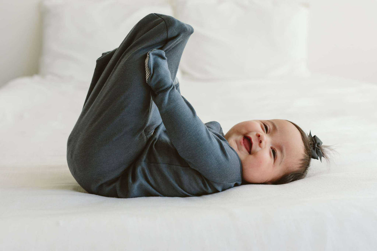 Quiet Night Starter Set newborn gown in midnight blue, soft knit fabric with enclosed feet and fold-over mitts