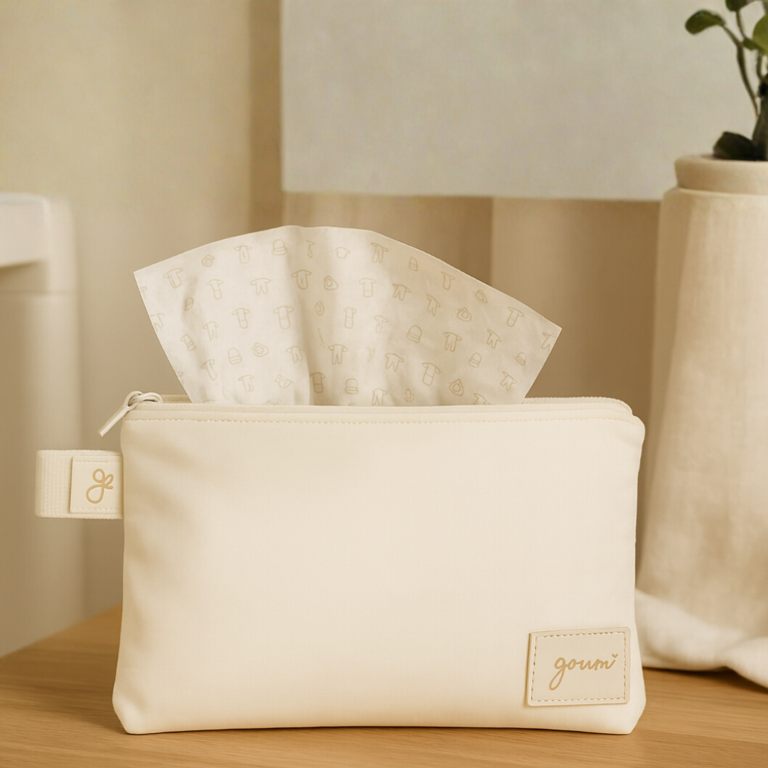 Signature gift wrap in a cream canvas pouch with a zip closure, branded tag, and patterned tissue paper