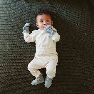 STAY ON 2-PACK MITTS in soft white fabric, worn by a baby with pale gray cuffs and a secure wrist fit