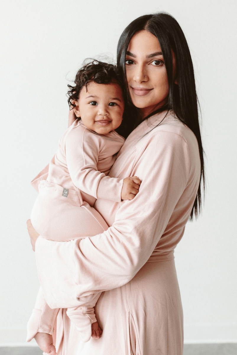 Womens Robe in soft blush pink, with a smooth fabric finish, long sleeves, and a relaxed wrap style.