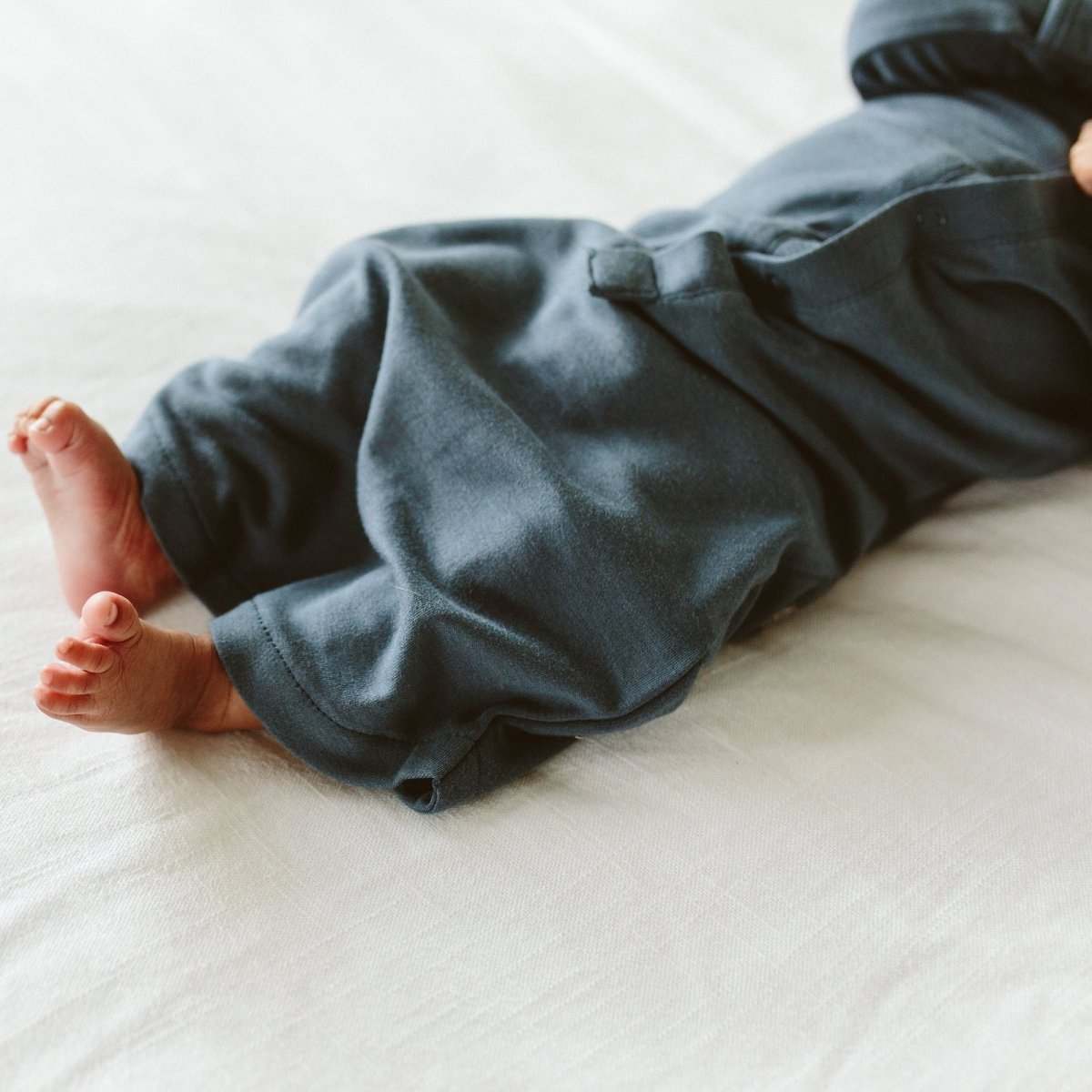 24 HOUR CONVERTIBLE GOWN in charcoal gray, soft solid fabric, shown converted to sleeper pants with a snap closure