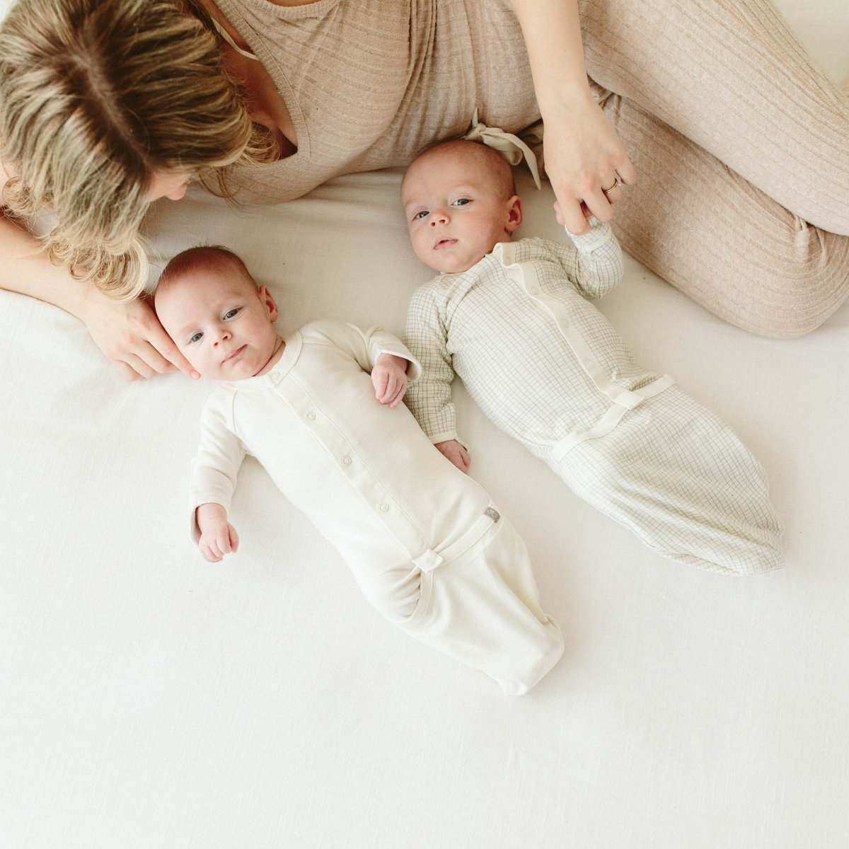 24 HOUR CONVERTIBLE GOWN in soft ivory ribbed fabric, shown on two babies with snap closures and gathered gown hems