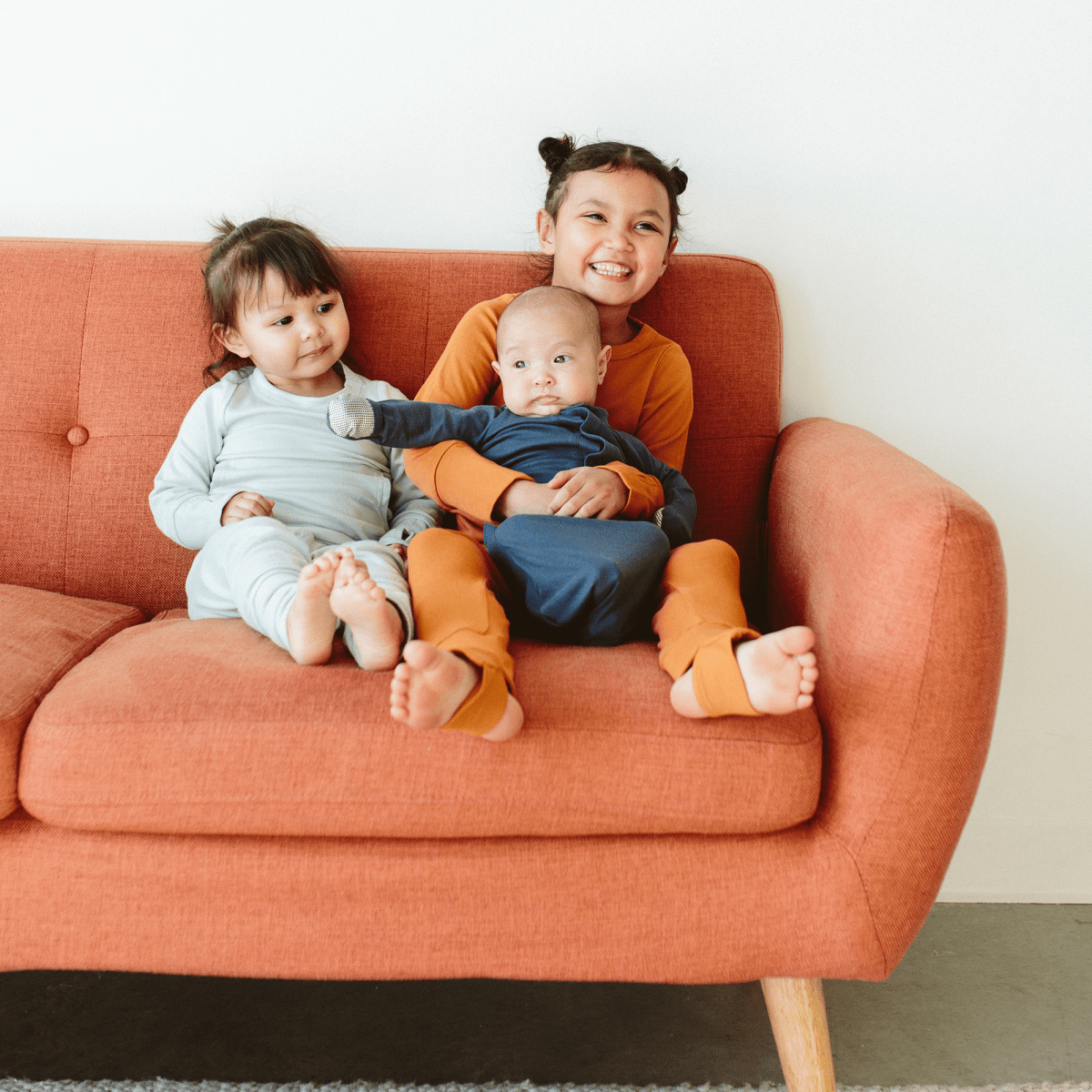 24 HOUR CONVERTIBLE GOWN in midnight navy, a soft long-sleeve baby sleeper with built-in fold-over mitts