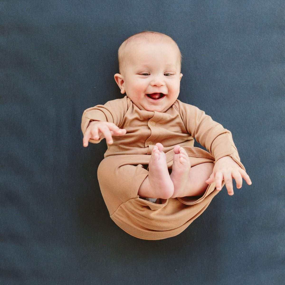 24 HOUR CONVERTIBLE GOWN in warm sandstone, a solid-color, soft bamboo cotton baby gown with long sleeves and a convertible design