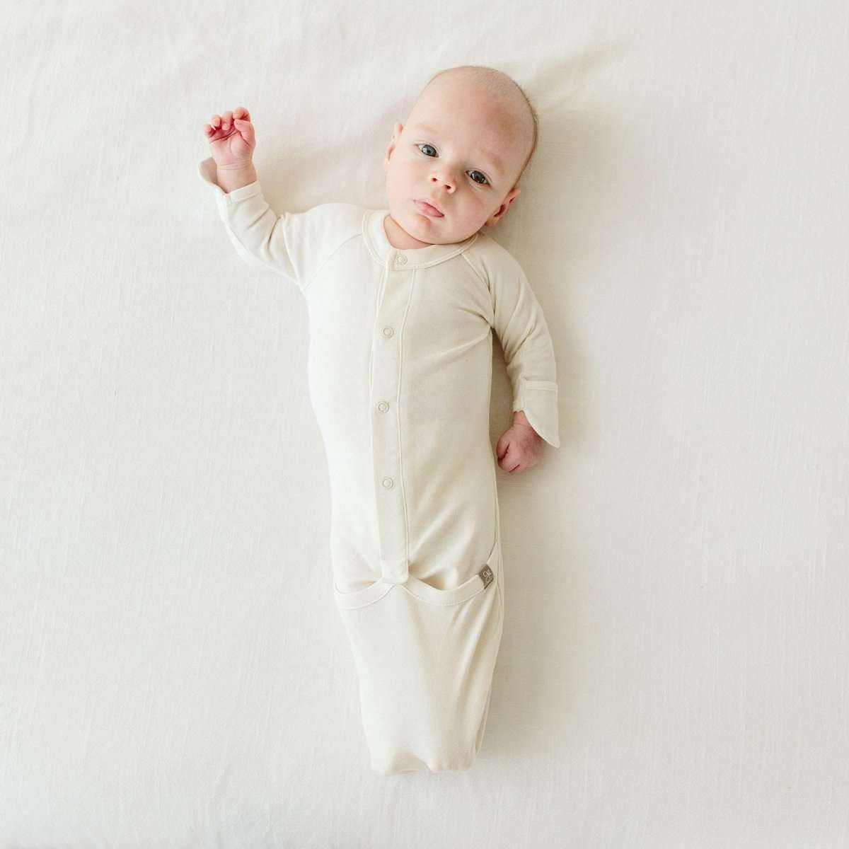 PREEMIE 24 HOUR CONVERTIBLE GOWN in soft cream, featuring long sleeves, front snaps, and a convertible foot pocket