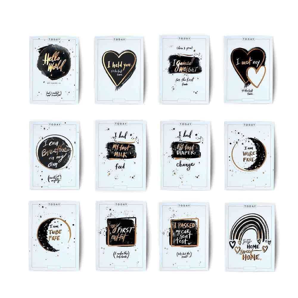 PREEMIE MILESTONE CARDS in pale blue and white, with black and gold hand-lettered milestone designs and speckled details.
