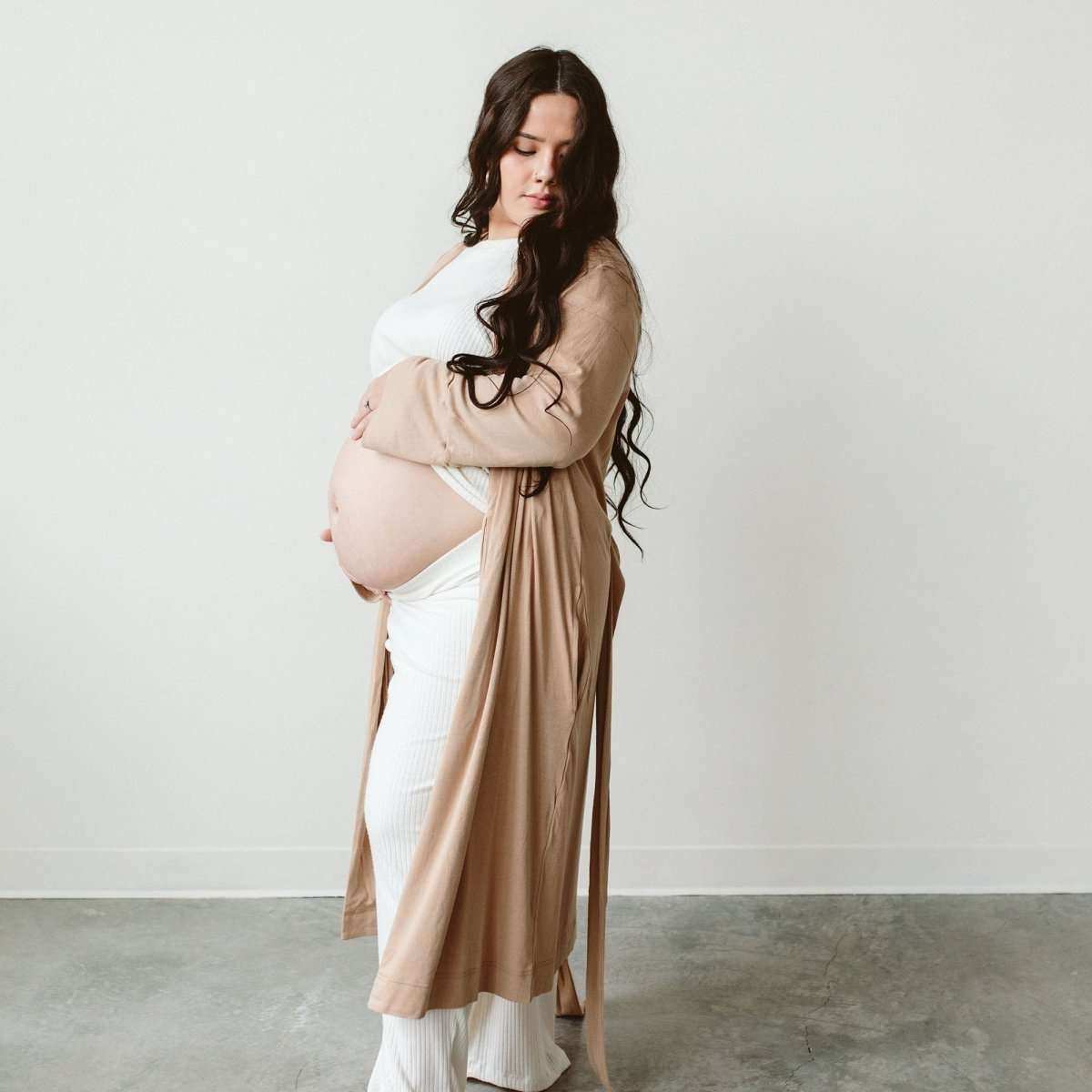 Second Chance Womens Robe in sand beige, a long soft-knit wrap with a matching waist tie worn over a white outfit
