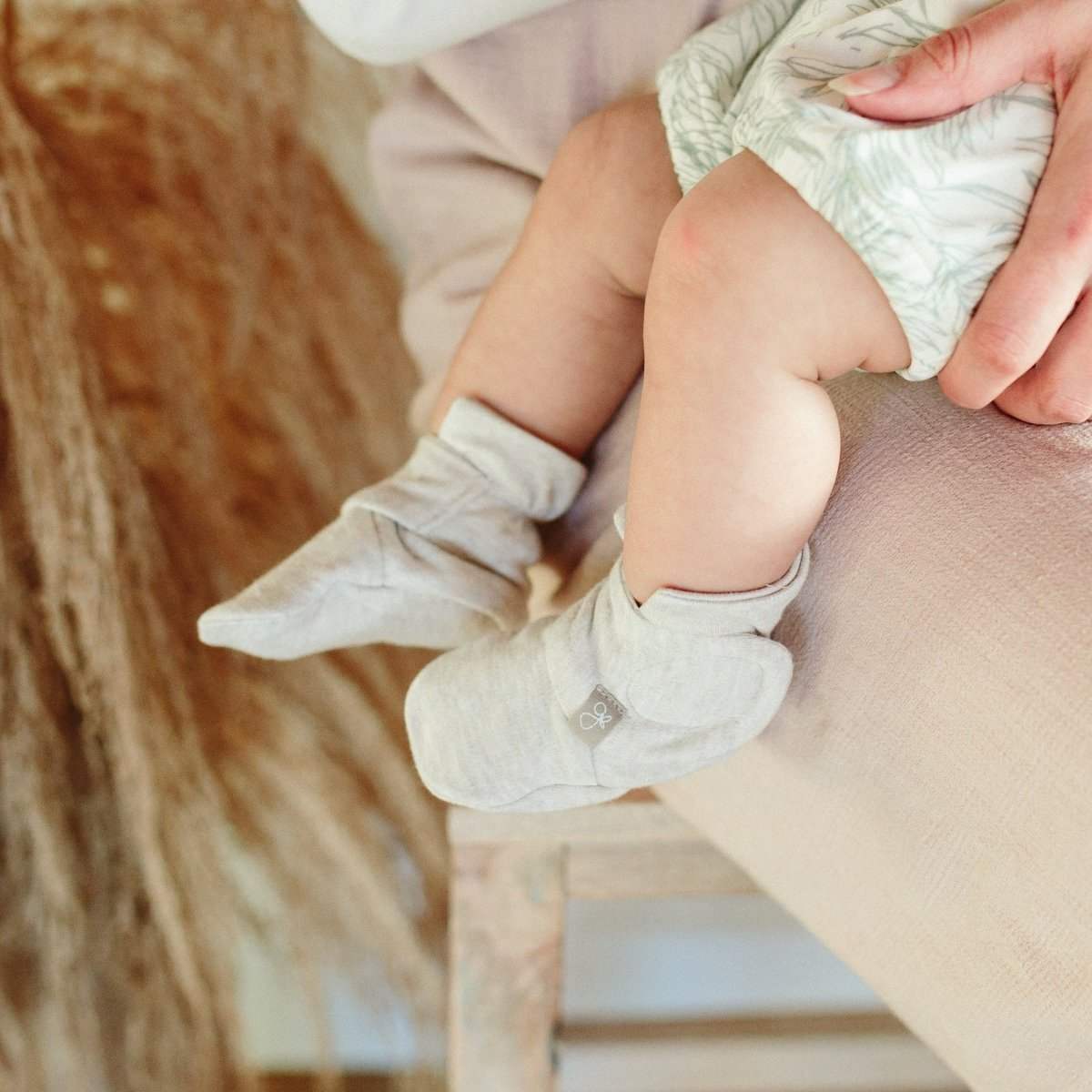 STAY ON 2-PACK BOOTS are soft light gray baby booties with folded cuffs and a small embroidered detail.
