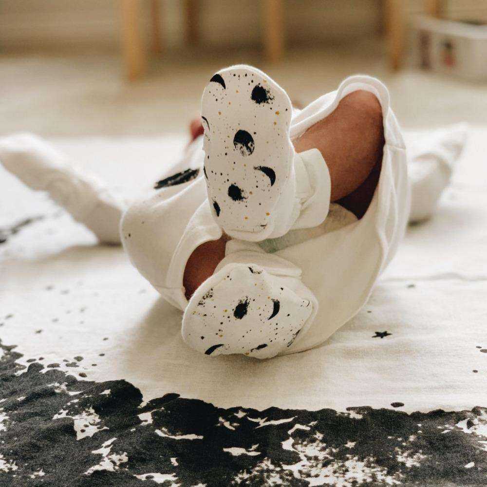 STAY ON 2-PACK BOOTS in soft white fabric with adjustable closures and cream soles printed with black moons and speckles