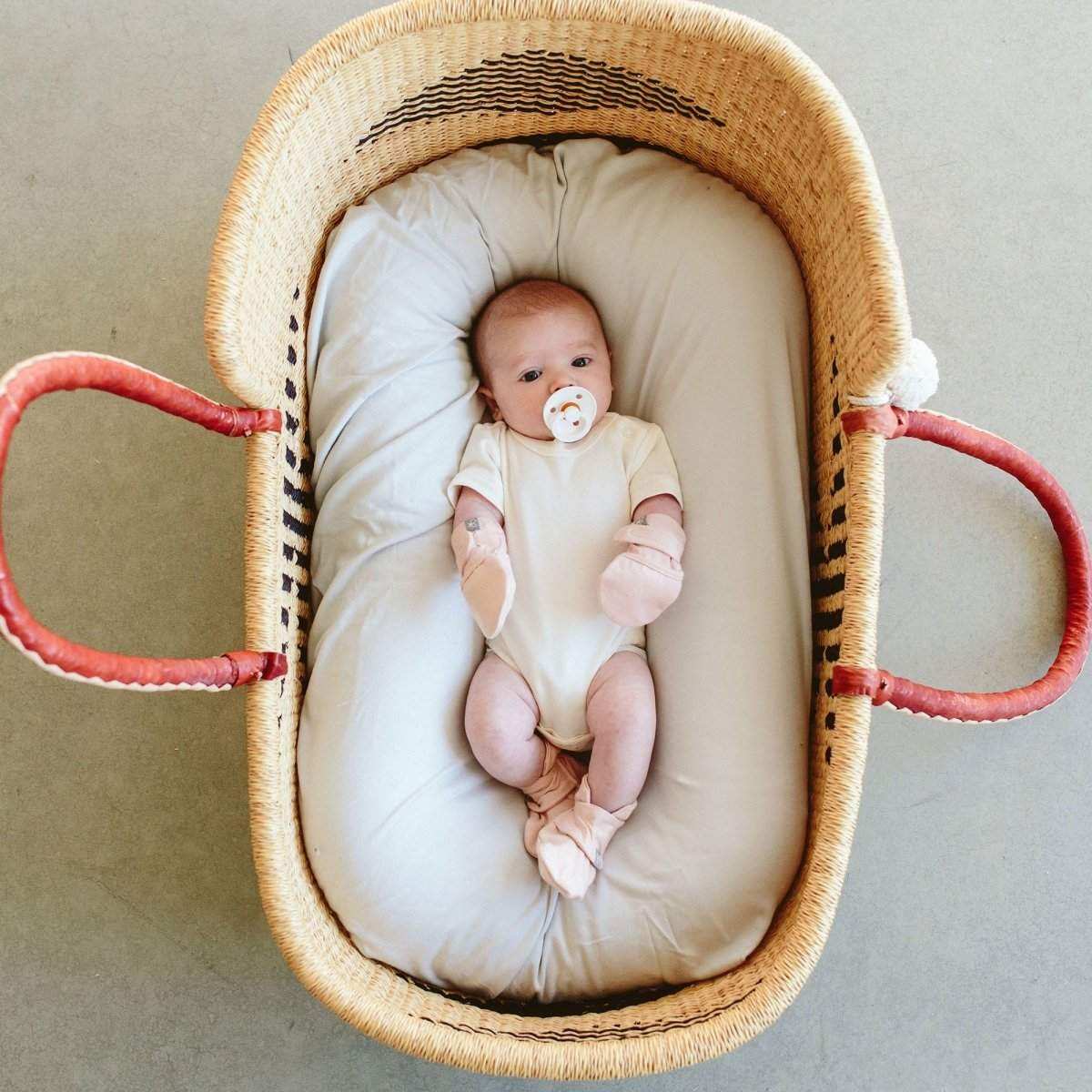 Stay On Boots rose baby booties in soft bamboo cotton blend with adjustable closures on an infant